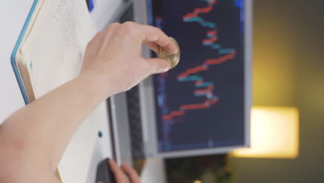 Vertical-video-of-Investor-examining-cryptocurrency-chart.-She-has-bitcoin.